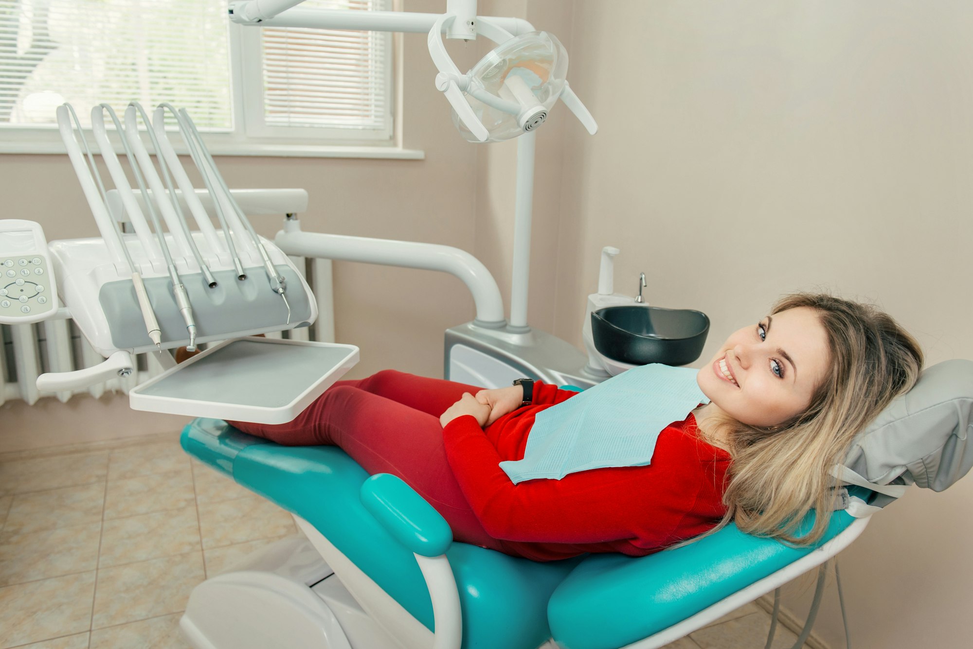 Smiling female patient in the dentists chair